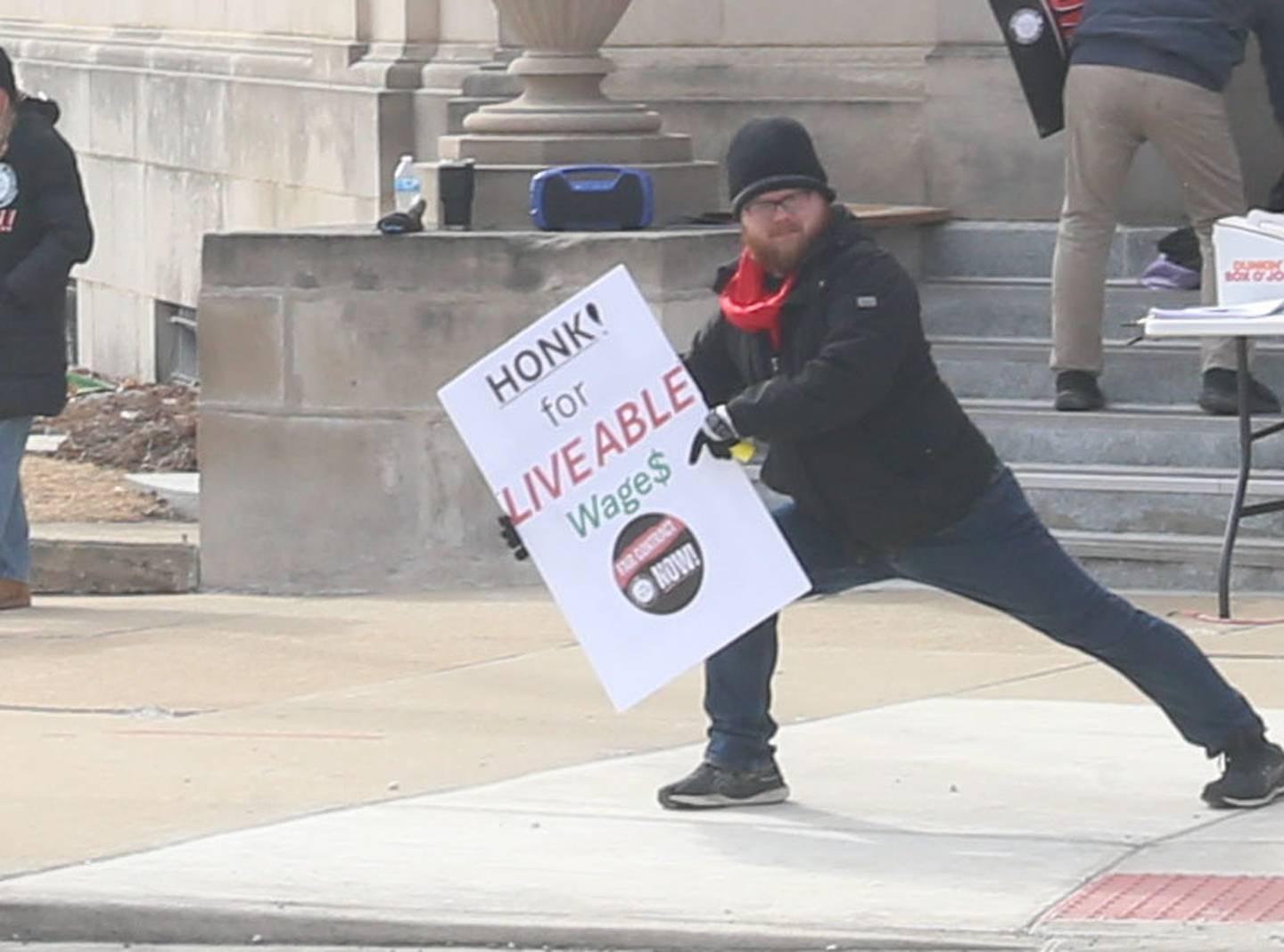 Devin Broderick poses with his "Honk for Liveable Wage$" sign during A “Fight Like Hell” rally held by the National Association of Letter Carriers on Sunday, Feb. 22, 2026 at the United States Post Office in Peru.