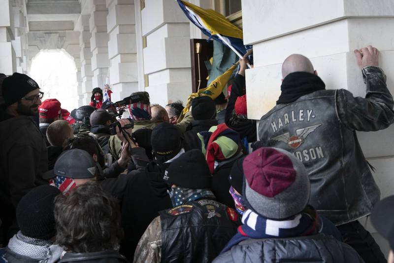 FILE - In this Jan. 6, 2021 file photo insurrectionists loyal to President Donald Trump try to open a door of the U.S. Capitol as they riot in Washington. New internal documents provided by former Facebook employee-turned-whistleblower Frances Haugen provide a rare glimpse into how the company, after years under the microscope for the policing of its platform, appears to have simply stumbled into the Jan. 6 riot (AP Photo/Jose Luis Magana, File)