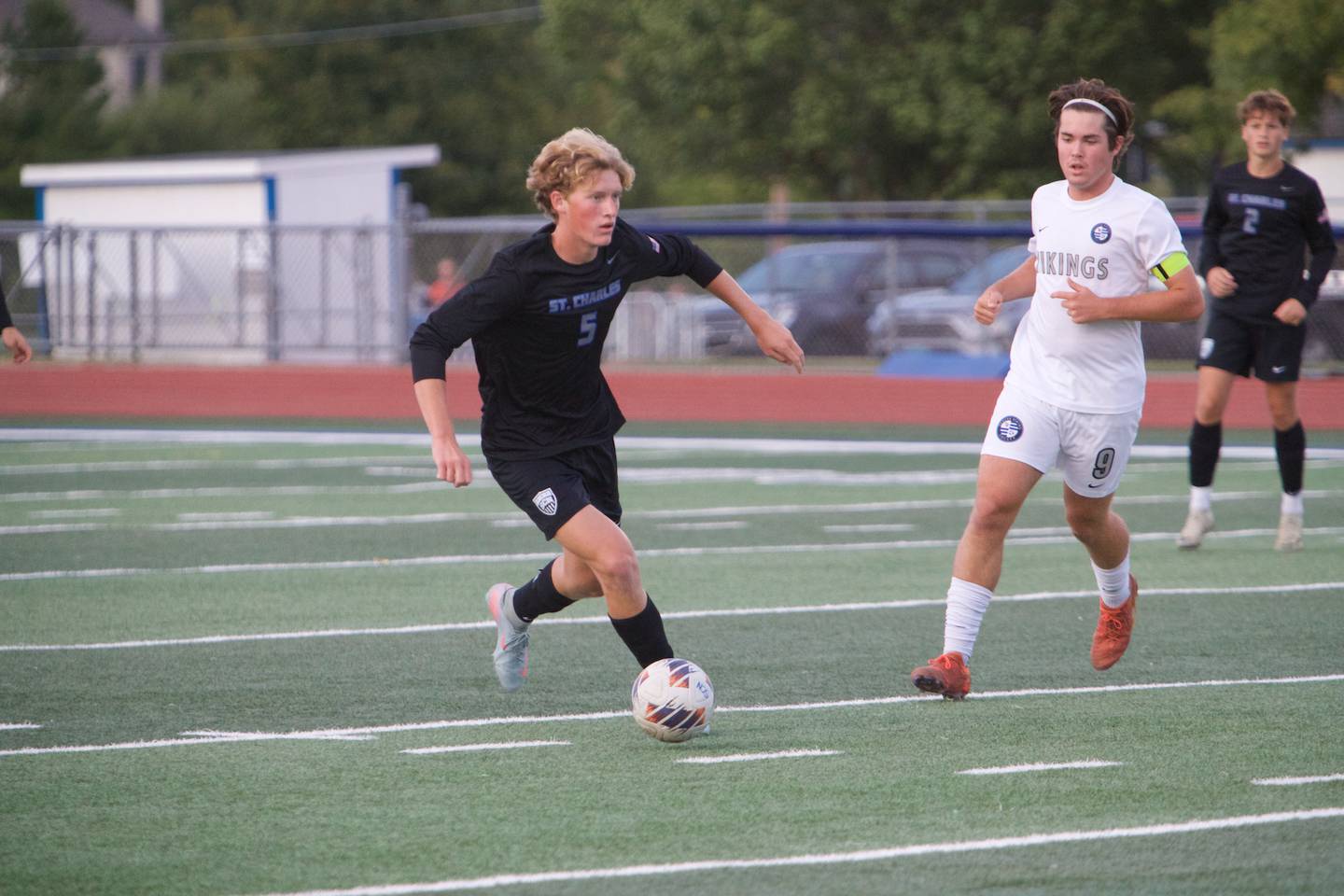 St. Charles North's Jacob Piper controls the ball against Geneva's Caleb Kelly on Tuesday, Sept. 9,2025 in St. Charles.