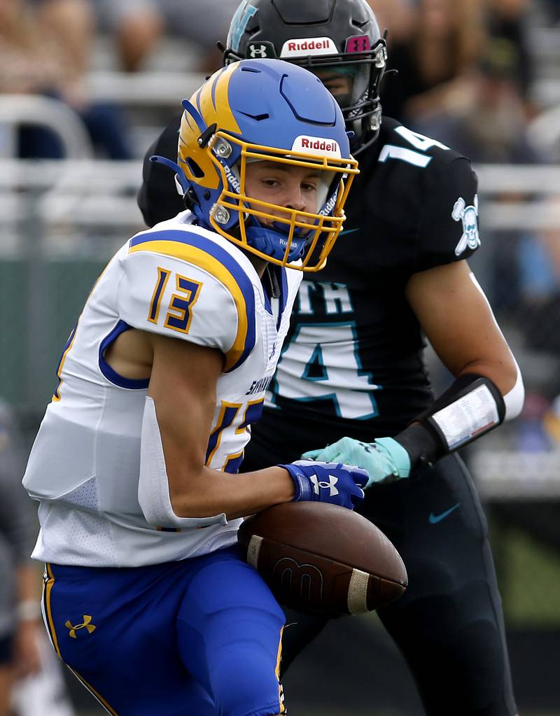 Johnsburg's Carter Block tries to catch the ball in front of Woodstock North's Dillon Morrison during a Kishwaukee River Conference football game Saturday, Aug. 26, 2023, at Woodstock North High School.