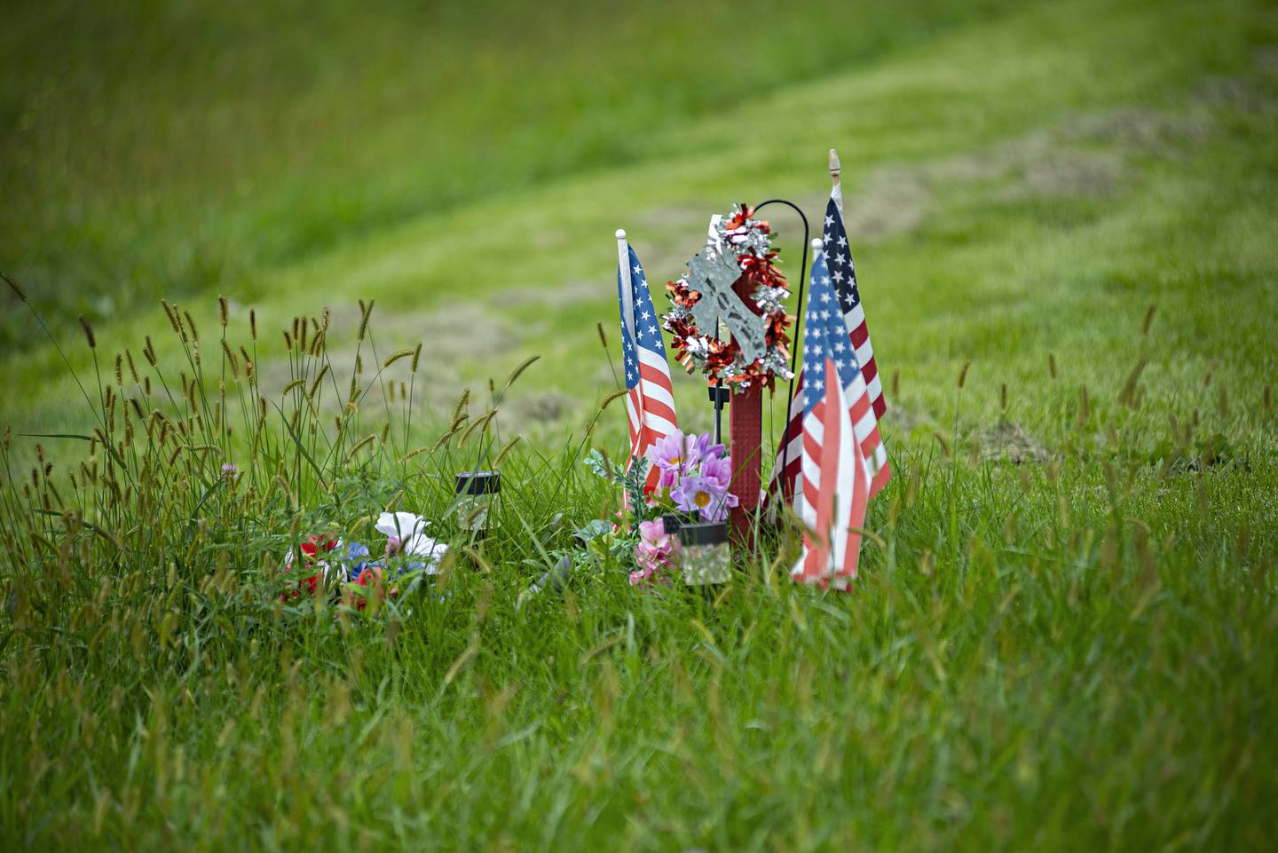 A memorial sits at the site on West Fourth Street in Sterling where Terry Jones was killed on a motorcycle last year.