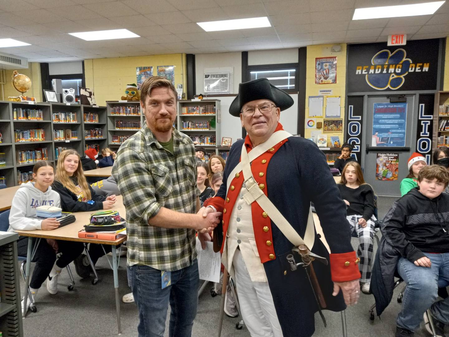 Princeton Logan Junior High School teacher David Gray and Dick Wells, a Neponset retired Lt. Col. who likes to share lively Revolutionary War lessons, pose for a photo Wednesday, Dec. 20, 2023.