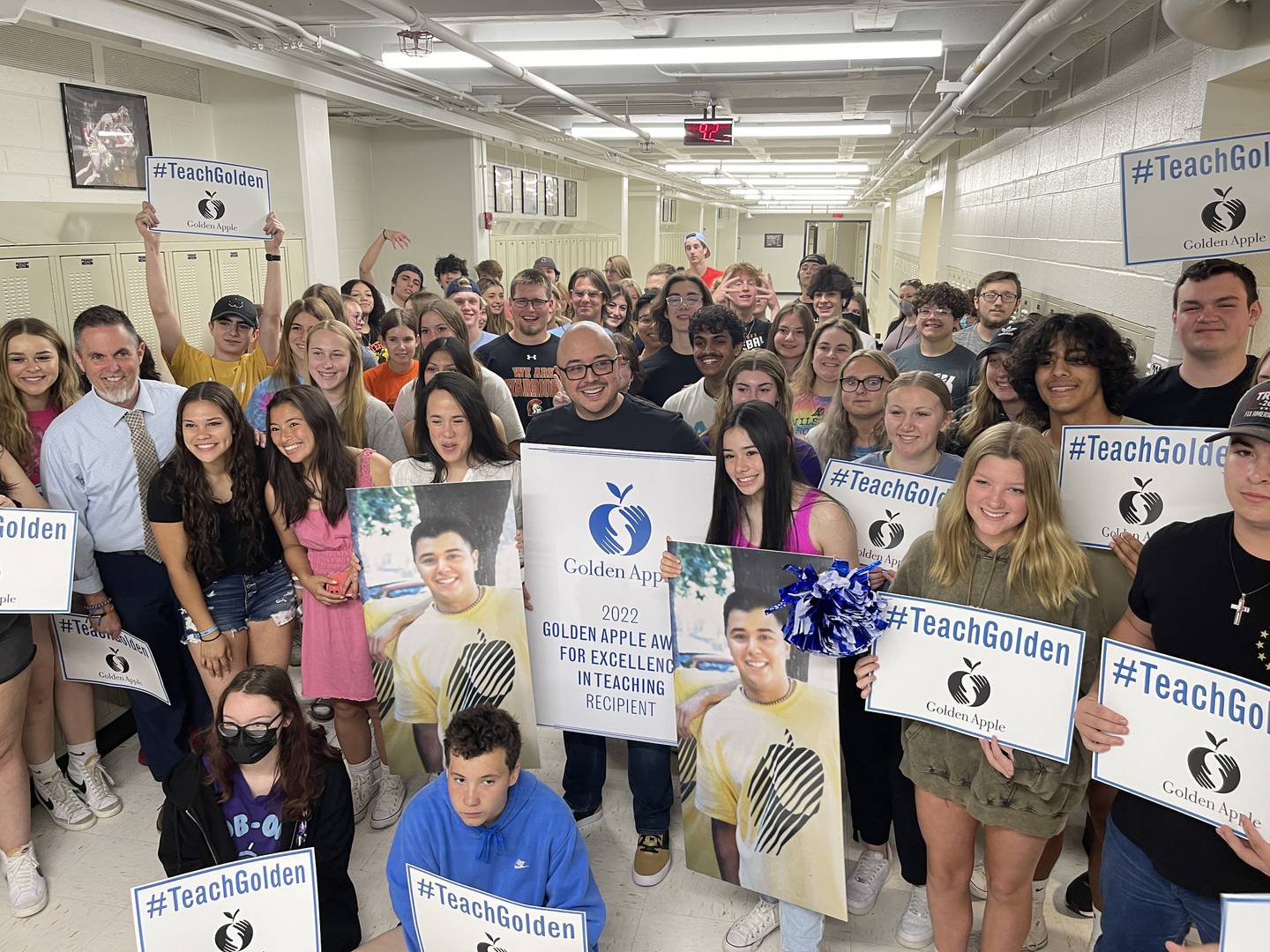 Otto Corzo, in the center, is surrounded on Friday, May 13, 2022, by his family and students, who help him celebrate his Golden Apple Award for Excellence in Teaching.