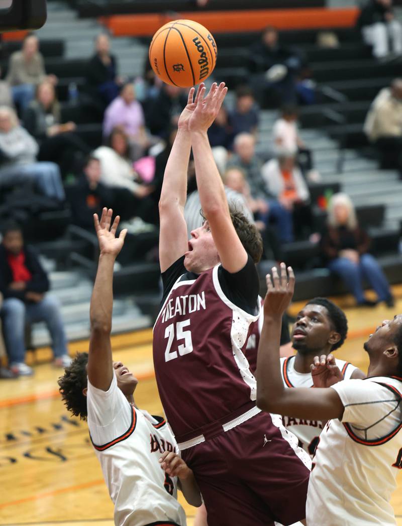 Wheaton Academy's Jackson Snider shoots over DeKalb's Bryan Miller during their game Wednesday, Jan. 14, 2026, at DeKalb High School.