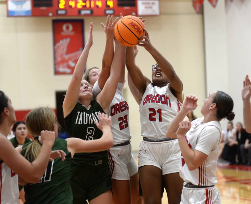Oregon's Aniyah Sarver (23) and Alease McLain (21) battle West Carroll's Avery Mangler (2) for a rebound at the Oregon Girls Basketball Tip-Off Tournament on Wednesday, Nov. 20, 2024 at the Blackhawk Center in Oregon.