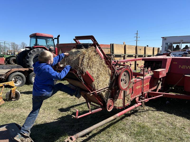 Cayson Wolf, 5, of Dixon, checks out a hay baler at the Hazelhurst Annual Spring Consignment Auction Saturday, April 6, 2024. Cayson was at the sale with his dad. The annual event is held each year on a farm along Milledgeville Road, between Polo and Milledgeville.