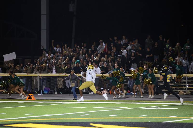 Bishop McNamara's Julius May breaks away from Herscher defenders for an 87-yard touchdown to secure a 38-28 lead near the end of the fourth quarter during the Fightin' Irish's 45-28 victory over Herscher on Friday, Sept. 5, 2025.