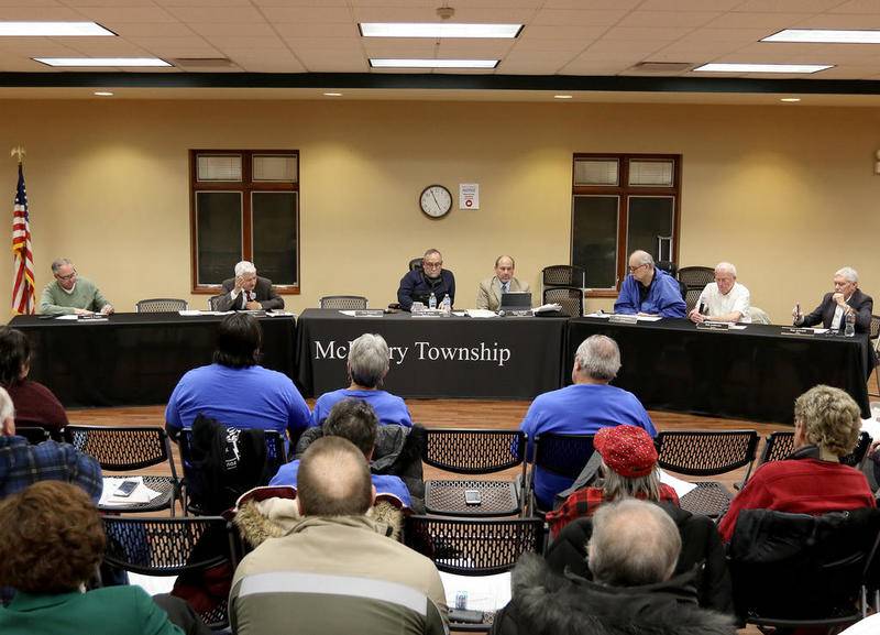 Attendees listen in as McHenry Township trustees during a special meeting held Dec. 20, 2019, in Johnsburg.