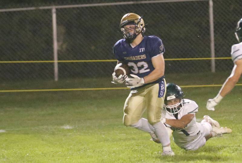 Marquette's Grant Dose eyes the end zone as St. Bede's Jose De Le Tore fails to bring him down on Friday, Sept. 26, 2025 at Gould Stadium in Ottawa.