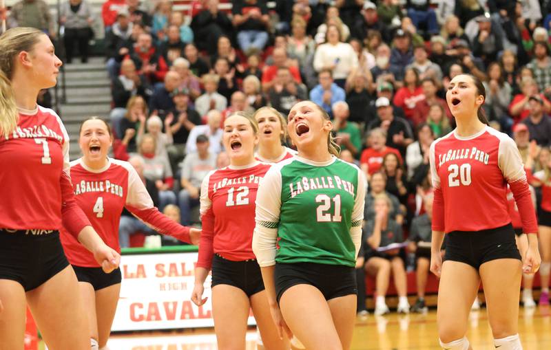L-P volleyball players (from left) Aubrey Duttlinger, Alexus Hines, Emma Jereb, Kelsey Frederick, Karmen Piano and Anna Riva react after scoring a point against Washington during the Class 3A Sectional final game on Thursday, Nov. 6, 2025 in Sellett Gymnasium at L-P High School.