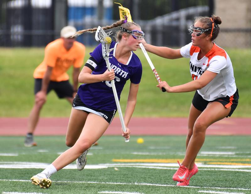 Downers Grove North’s Ashley Poquette circles around Crystal Lake’s Fiona Lemke during the Benet Supersectional game on June 3, 2025 at College of DuPage in Glen Ellyn.