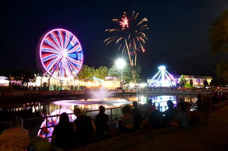 Attendees watch the fireworks show over the carnival during the 2023 Bourbonnais Friendship Festival at the Bourbonnais Municipal Center.