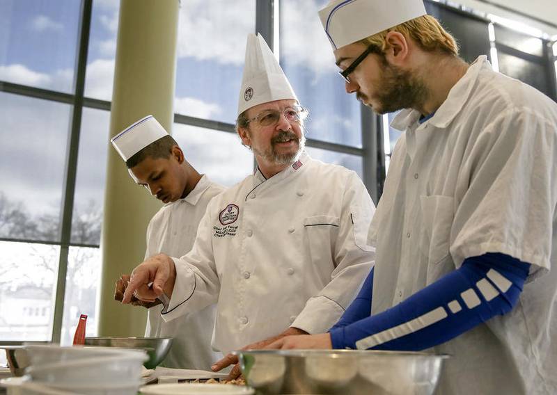 Chef Fred Ferrara watches over his students Wednesday in the Vocational Skills Food Service Partnership classes as they prepare several dishes for a meal at Joliet Junior College in Joliet.