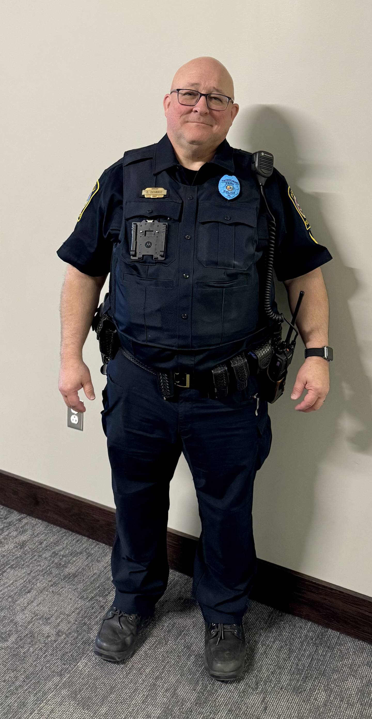Peru police Sgt. Ed DeGroot wears the blue badge that all officers will wear in honor of Autism Awareness Month in April 2025.