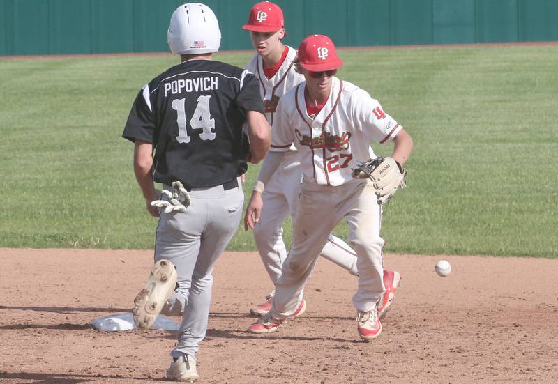 Kaneland's Preston Popovich runs safely to second as L-P's Grey Ernat makes an error while teammate Jett Hill watches from behind on Tuesday, May 13, 2025 at Huby Sarver Field at the L-P Athletic Complex in La Salle.