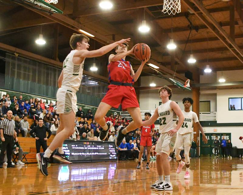 Glenbard South's Ben Zima, center, goes up for a shot in the first quarter while being defended by Glenbard West's Dominic Seaney, left, and teammate Glenbard West's Bennett Schwnanke, right, on Monday Nov. 20, 2023, during the district 87 Invite held at Glenbard west.