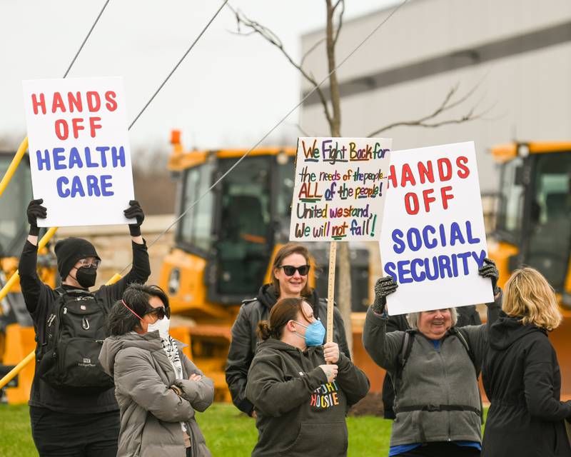 Community members line Ogden Ave. outside the Tesla dealership on Saturday April 5, 2025, in Lisle during the Hands Off Demonstration.