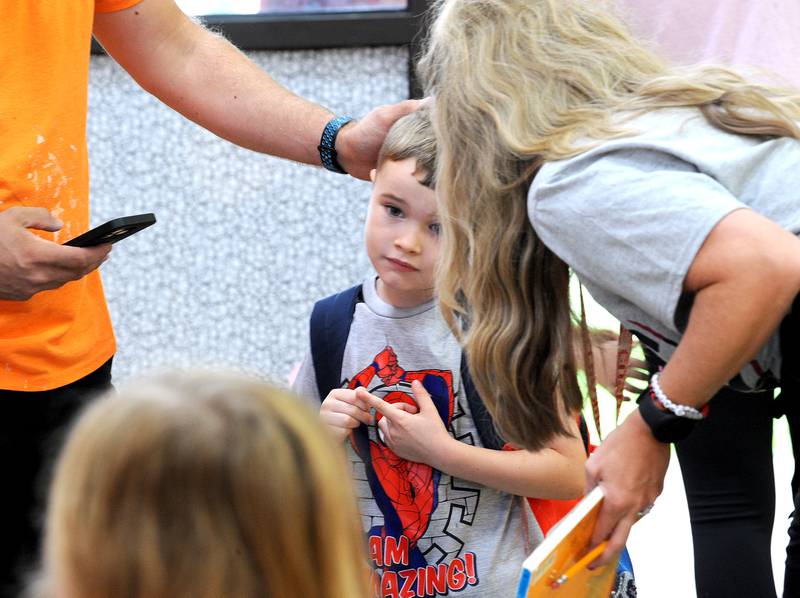 Kindergartener Lincoln Grandchamp meets his teacher on the first day of classes at Yorkville Grade School on Friday, Aug. 15, 2024.