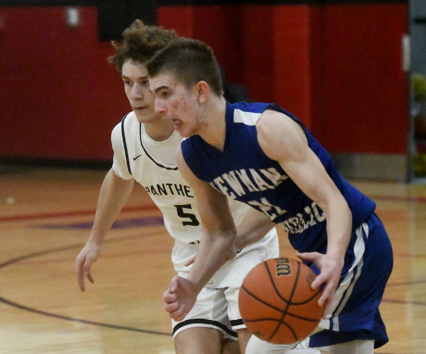 Newman's Cody McBride brings the ball up the court as Erie-Prophetstown's Jeremiah Kochevar defends during Friday, Dec. 29, 2023 action at the Warkins Memorial Tournament at Erie High School.