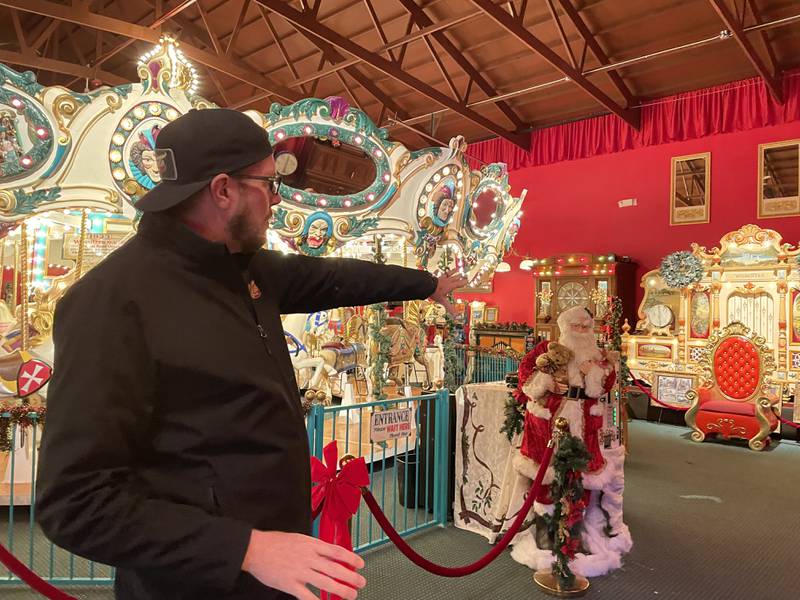Volo Museum Marketing Director Jim Wojdyla points out the spot where Santa will visit with children in the Coney Island Carousel Room at Volo Museum during the first three weekends in December. The building's centerpiece is a meticulously restored, fully functional 1920s Herschell carousel, on which those visiting with Santa may also take a spin with him.
