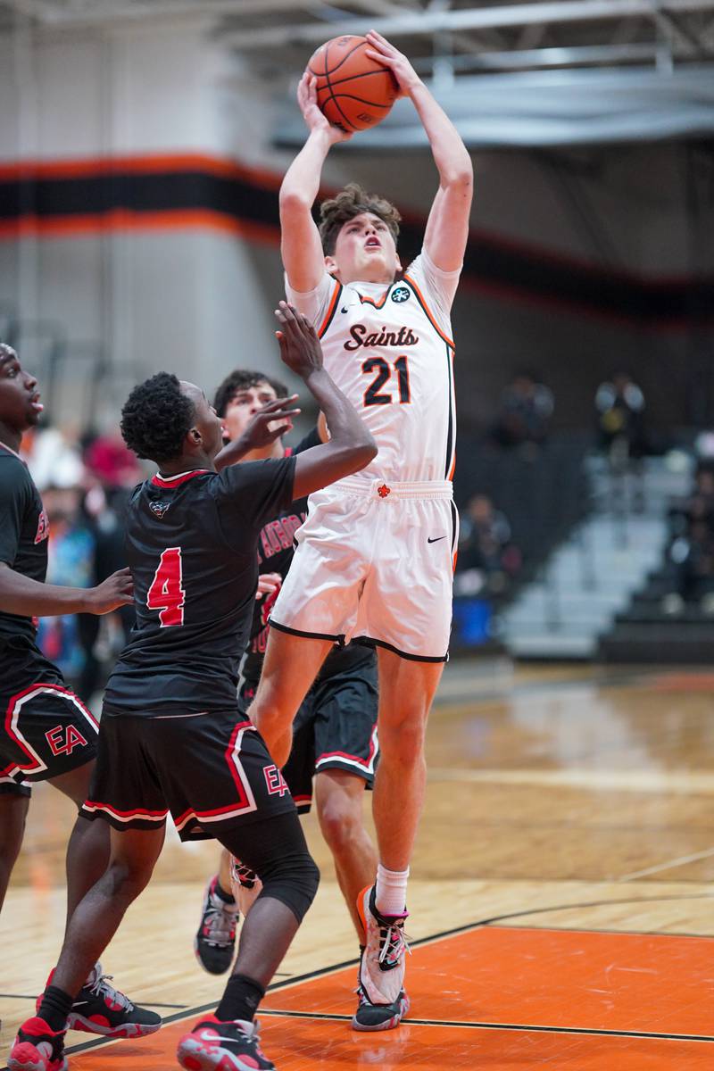 St. Charles East's Jacob Vrankovich (21) shoots the ball in the post over East Aurora's Kenneth Cooley (4) during the 64th annual Ron Johnson Thanksgiving Basketball Tournament at St. Charles East High School on Monday, Nov 20, 2023.