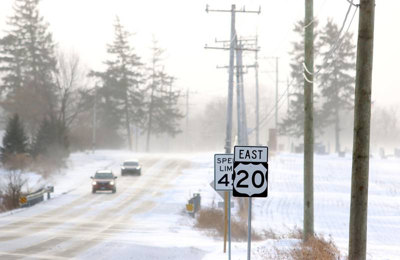 Motorists emerge Friday morning from drifting snow outside Marengo as bitter cold and heavy winds moved in the wake of Thursday snowfall.