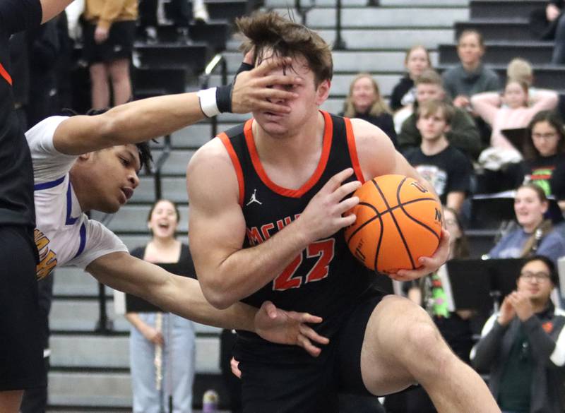 Warren’s Avonn King, left, gets a hand in front of McHenry’s Conner McLean in IHSA Class 4A Regional Title Game boys basketball action on Friday, Feb. 28, 2025 at McHenry High School in McHenry.