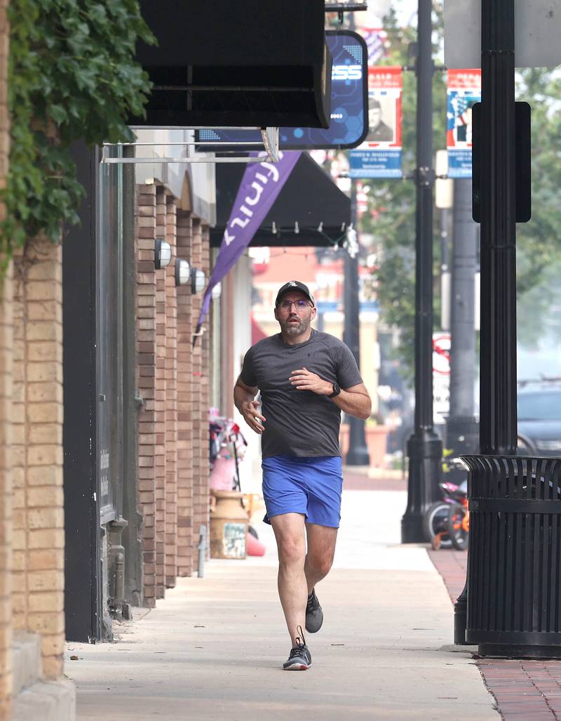 Shawn Beck, from DeKalb, runs west Wednesday, June 28, 2023, on Lincoln Highway between First and Second Streets in DeKalb. Beck recently completed his goal of running every street in DeKalb County.