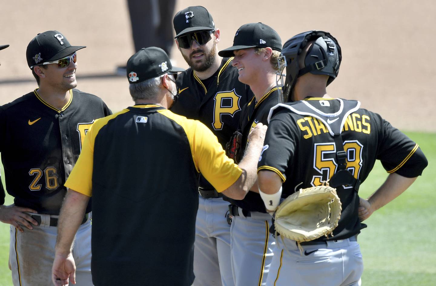 Pittsburgh Pirates manager Derek Shelton, front left, takes pitcher Quinn Priester out of a spring training game against the Baltimore Orioles on March 15, 2021, in Sarasota, Fla.