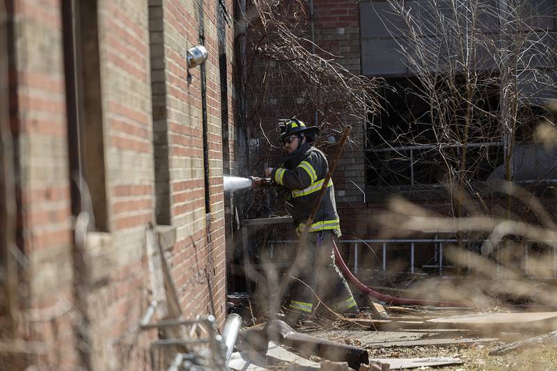 Dixon City firefighters work to extinguish hot spots in the afternoon on Monday, March 2, 2026, after previously fighting a fire in the 1100 block of West First Street. Dixon City responded to the fire at 2:21 a.m. and cleared the scene at 6:19 a.m.