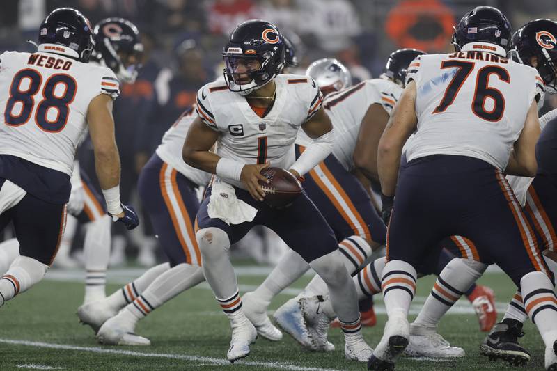 Chicago Bears quarterback Justin Fields hands the ball off during the second half, Monday, Oct. 24, 2022, in Foxborough, Mass.