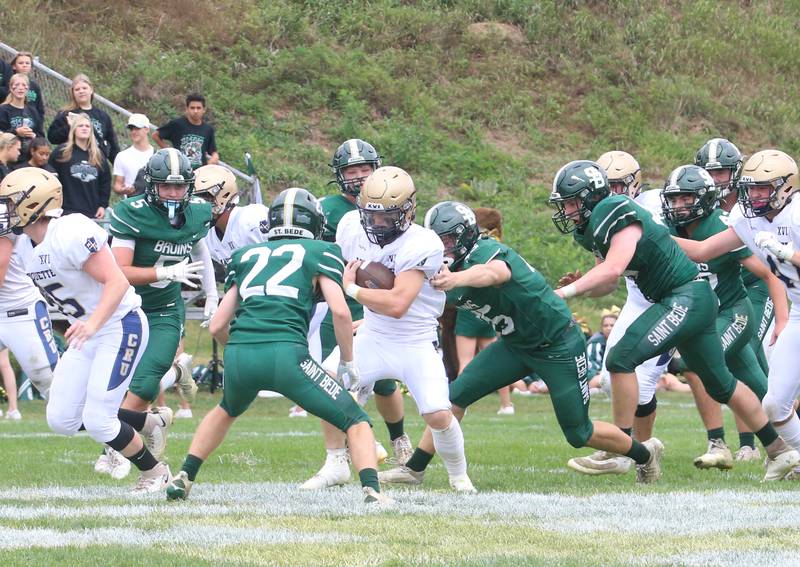 Marquette's Jaxsen Higgins (center) runs the ball against St. Bede during the Homecoming game on Saturday, Sept. 28, 2024 at St. Bede Academy.