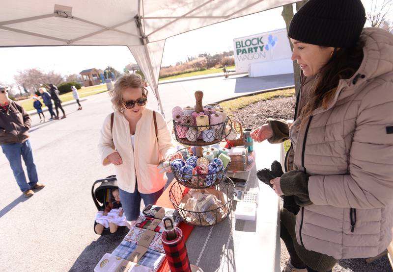 Emily Sanchez of Glen Ellyn (left) looks over waste free products sold by Zero Bull Shop owner  Michelle Weed during the Glen Ellyn Park District's Polar Market held at Maryknoll Park Saturday, Dec. 9, 2023.