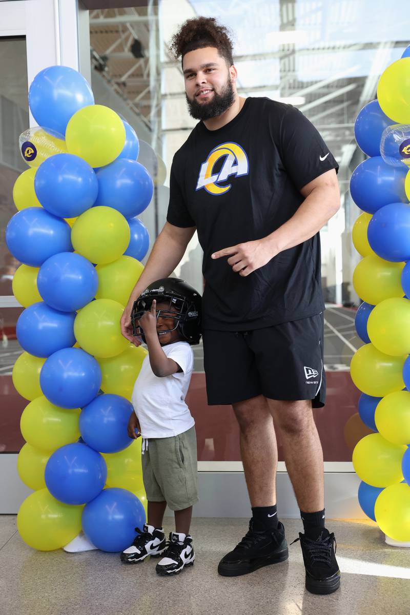 Young fan Makari Hammond, 4, poses for a photo with Keagen Trost, a 2019 Kankakee High School grad, during a celebration held for him at the school on May 4, 2026, following him being drafted into the NFL to the Los Angeles Rams.