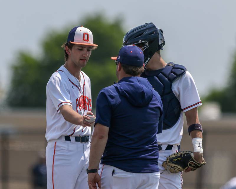 Oswego's Eddie Scaccia (22) hands the ball to the head coach Joe Giarrante during Class 4A Romeoville Sectional final game between Oswego East at Oswego.  June 3, 2023.