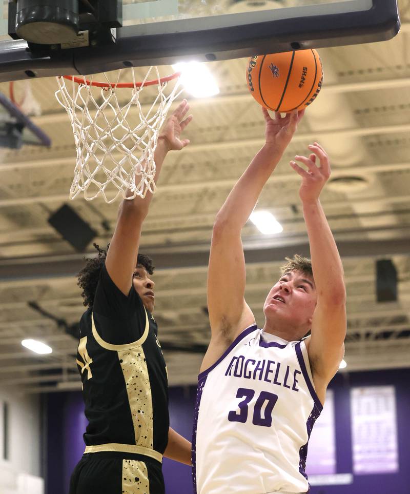Rochelle's Warren Schwietzer goes to the basket against Sycamore's Tyler Townsend Friday, Dec. 5, 2025, during their game at Rochelle High School.
