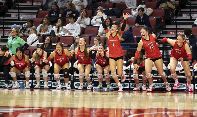 The Timothy Christian bench celebrates after beating El Paso-Gridley Saturday, Nov. 16, 2024, in the Class 2A third place state volleyball match at CEFCU Arena in Normal.
