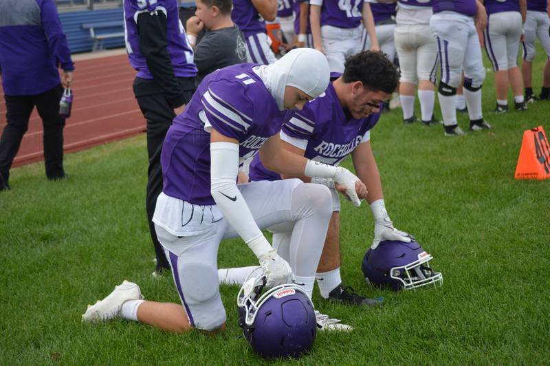 Rochelle junior varsity football players take a knee during a moment of silence and prayer for varsity player Dylan Manning during a game this week with Morris. Manning suffered a head injury during the Oct. 3 game at Morris and is in recovery from surgery at Loyola Medical Center.
