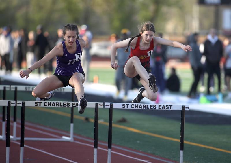 Hampshire’s Julia Vonic (left) and Batavia’s Abby Wirth compete in the 100-meter hurdles during the 2024 Kane County Girls Track and Field meet at St. Charles East on Thursday, April 25, 2024.