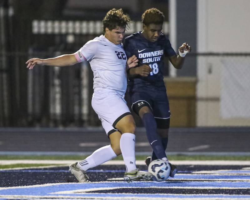 Downers Grove South's Zeke Hall-Taylor (18) lines up a corner shot past the defense of Downers Grove North's Kyle Wilson (22) during soccer match between Downers Grove North at Downers Grove South. Oct 2, 2025.