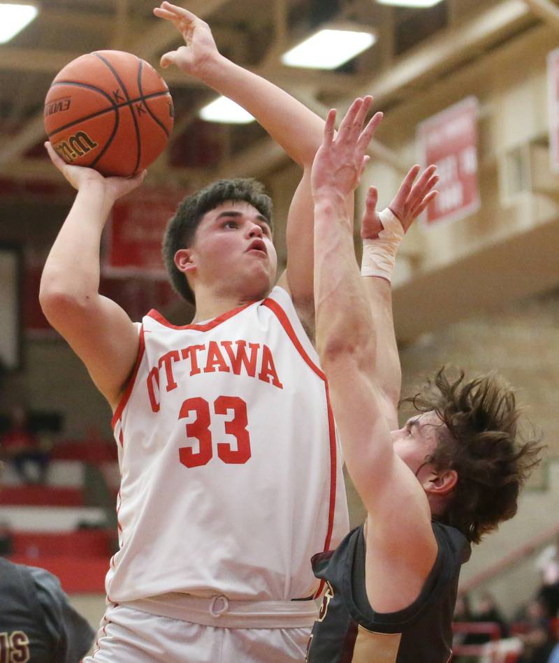 Ottawa's Cooper Knoll eyes the hoop as Morris's Caston Norris defends on Wednesday, Jan. 3, 2024 at Kingman Gym.