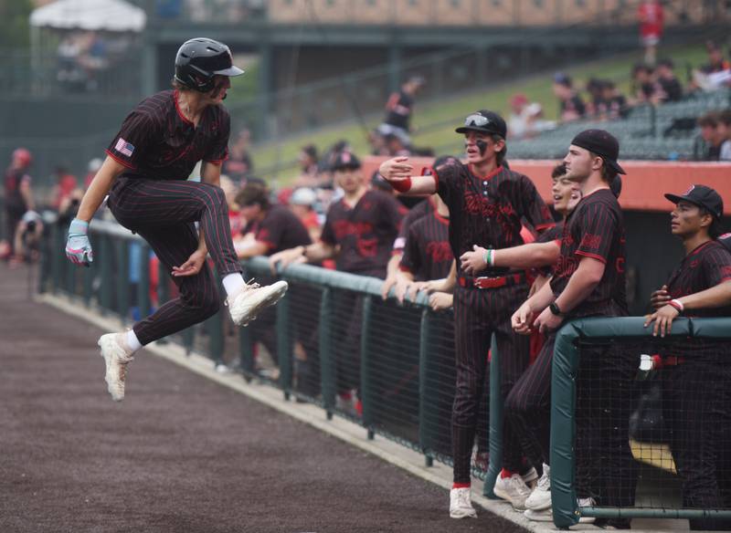 Benet Academy’s Nikolas Schaefer leaps toward the dugout  as the Redwings rally in  the top to the seventh on their way to defeating Cary-Grove 11-6 during the Class 3A state baseball semifinal at Slammers Stadium on Friday, June 13, 2025 in Joliet.