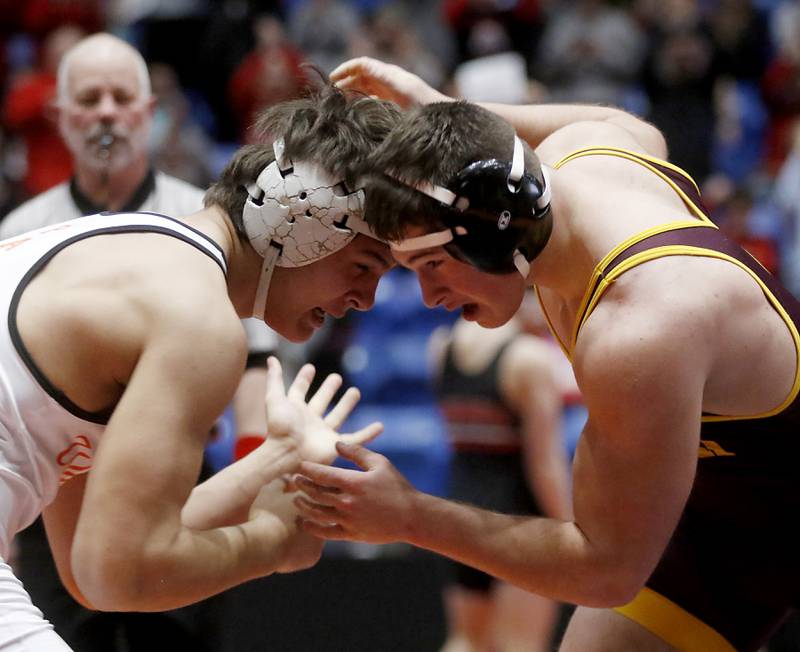 Washington’s Josh Hoffer battles with Montini's Alex Marre during the IHSA Class 2A Dual Team Sate Championship match Saturday, Feb. 24, 2024 at Grossinger Motors Arena in Bloomington.