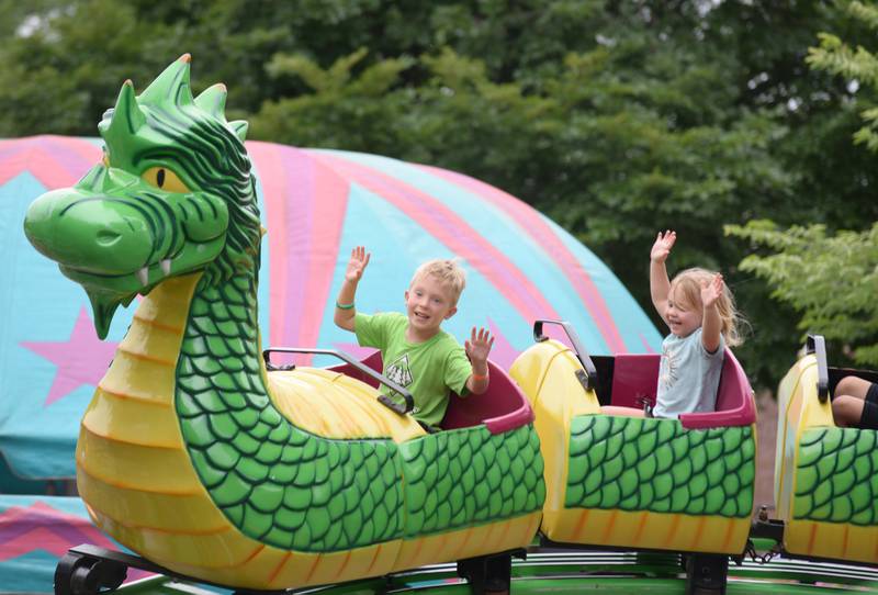 Bo and Faye Newline of Clarendon Hills enjoy riding the Dragon Wagon during the Taste of Westmont Friday July  8, 2022.