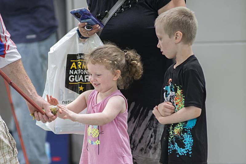 Delanie Dickey, 5, and older brother Declan, 7, check out a fish they reeled in Saturday, May 14, 2022 during the Sterling-Rock Falls Family YMCA’s Outdoor Adventure Fest. The pool at the Y was turned into a fishing hole for the day to allow families to try their hand at angling.