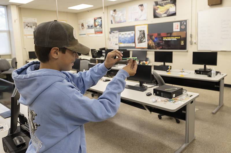 Wyatt Ebersole, 13, attempts to fire off his Q-tip crossbow Thursday, July 13, 2023. Each camper learned about a trade and made a project in the class.