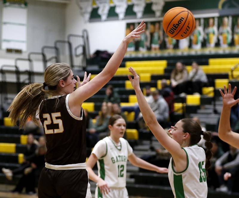 Jacobs' Olivia Schuster passes the ball over the defense of Crystal Lake South's Tessa Melhuish during a Fox Valley Conference basketball game on Friday, Jan. 17, 2025, at Crystal Lake South High School.
