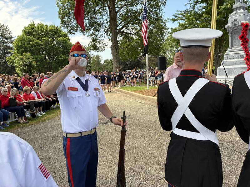 Ryan Bentolo of the Marine Corps League Detachment 1009 McHenry County takes a hydration break after walking the parade route, but before the Memorial Day Ceremony at Crystal Lake's Union Cemetery.