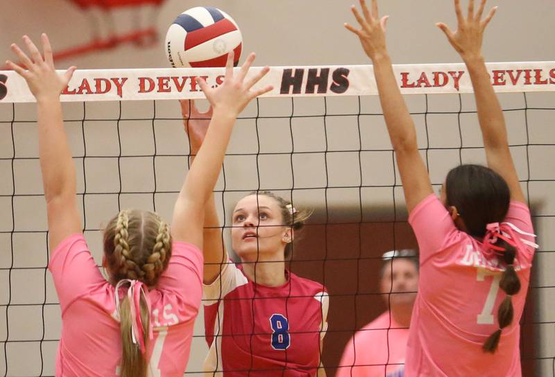 Princeton's Keighley Davis spikes the ball past Hall's Caroline Morris and teammate Haven Rossi on Thursday, Oct. 9, 2025 at Hall High School.