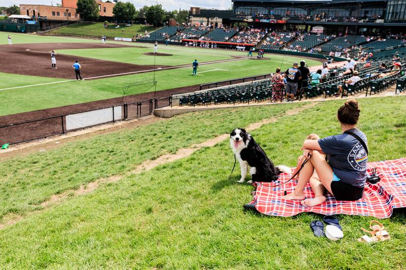 Wilmington residents Kelsey and Teagan Florey, along with Coast, enjoy lawn area during the Joliet Slammers Dog Day event, presented by University of St. Francis, on Aug. 10, 2025.